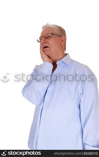 A very surprised senior man with his hand on his face and mouths openlooking up, isolated for white background.