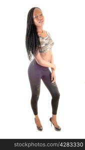 A very tall African American woman in black tights and long braided blackhair standing isolated for white background.