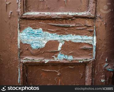 A very worn and battered old brown door