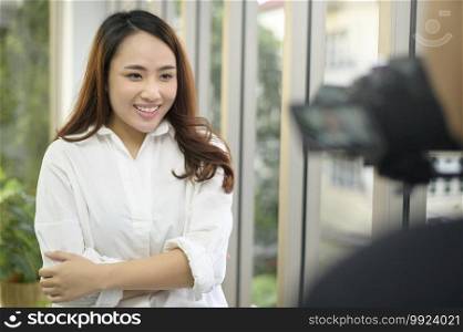 A video camera recording of confident beautiful businesswoman being interviewed, behind the scene concept,. Video camera recording of confident beautiful businesswoman being interviewed, behind the scene concept,