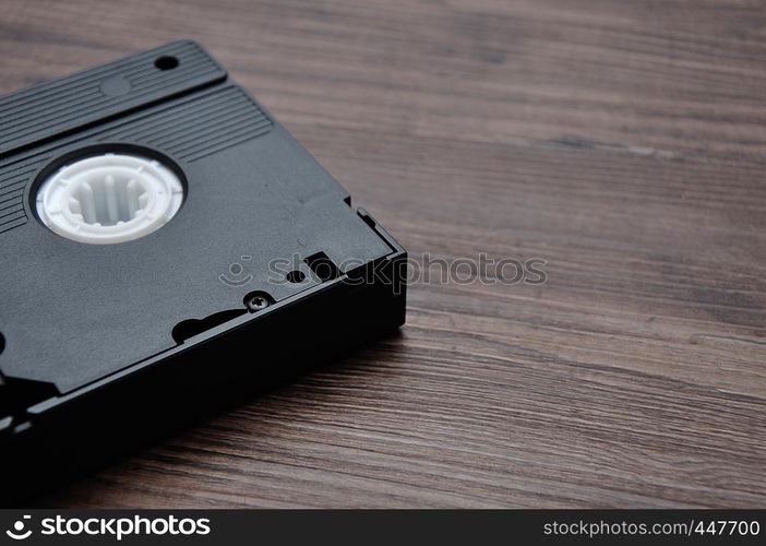 A video cassette isolated on a wooden background