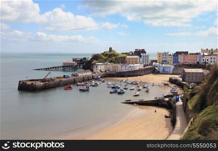 A view across the old harbour in Tenby, Pembrokshire, Wales, with the old and new lifeboat stations top left.