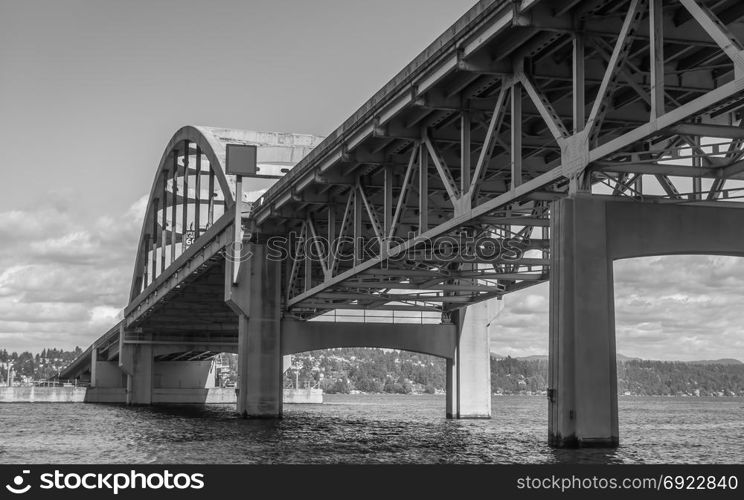 A view from under the I-90 bridge in Seattle, Washington. Black and white image.