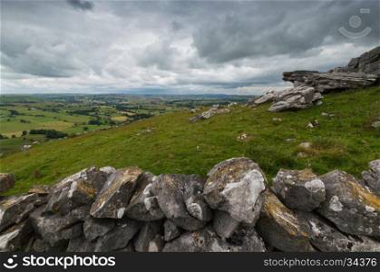 A view from Wolfscote Hill in the Peak District, Derbyshire, with a stone wall in the foreground