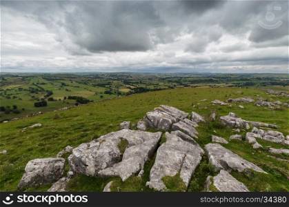 A view from Wolfscote Hill in the Peak District, Derbyshire, with rocks in the foreground