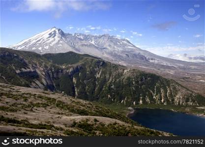 A view inside the crater of Mt. St. Helens looking over a low mountain ridge and a corner of Spirit Lake.