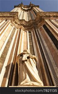A view looking upwards to the top of one of the twin belltowers of the main cathedral, the Duomo, in Orvieto. The extreme perspective foreshortens the tower.