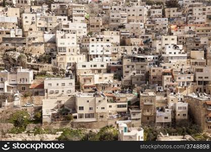 A view of a crowded part of East Jerusalem in Israel where buildings are stacked up over hillside.