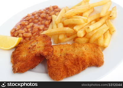 A view of a meal of fried breaded fish fillets served with chips, baked beans and a lemon wedge
