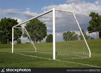 A view of a net on a vacant soccer pitch.. Looking Up at the Net