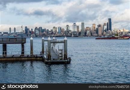 A view of a pier with the Seattle skyline across the water.