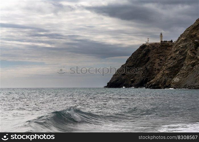 A view of La Chucha Beach and the lighthouse of Cabo Sacratif in Andalusia