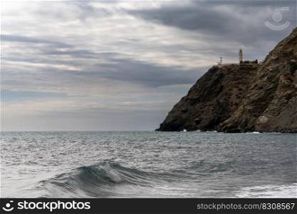 A view of La Chucha Beach and the lighthouse of Cabo Sacratif in Andalusia