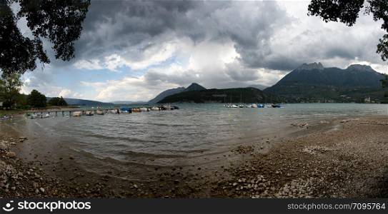 a view of Lake Annecy with cloudy sky