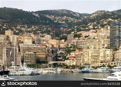 A view of Monte Carlo, captured from the marina, filled with boats of all sizes and monetary worth.