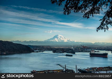 A view of moored boats in the Port of Tacoma with Mount Rainier in the distance.