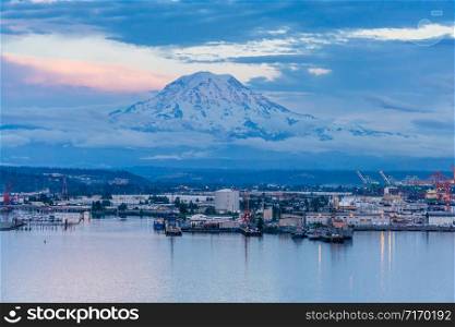A view of Mount Rainier and the Port of Tacoma at twilight.