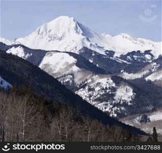 A view of Mt. Daly in the Elk mountain range in Colorado. A view of wilderness capped with a snow-covered peak.
