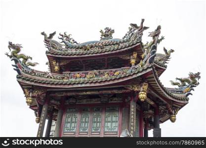 A view of one of the pagodas overlooking the main courtyard at the Mengjia Longshan Temple in Taipei shows the colorful dragons, phoenixes, and other creatures at each of the four corners of the roof.