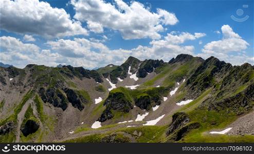 a view of Pyrenees mountains with cloudy blue sky