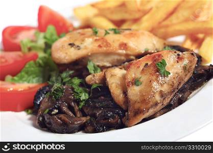 A view of roast chicken breasts on a bed of mushrooms, served with fried potato chips and a tomato and lettuce salad