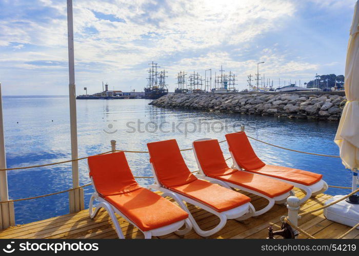 A view of sun loungers amid sailboats in the town of Kemer.