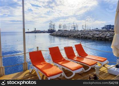 A view of sun loungers amid sailboats in the town of Kemer.
