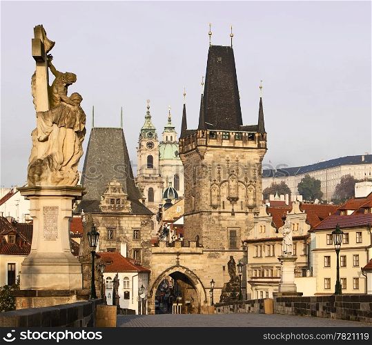 A view of the Charles Bridge landmark looking towards Lesser Town with the bridgetower in the foreground and Prague Castle in the background.