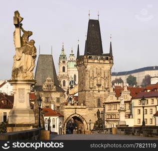 A view of the Charles Bridge landmark looking towards Lesser Town with the bridgetower in the foreground and Prague Castle in the background.