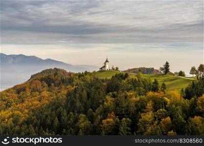 A view of the Church of Saint Primoz and the Julian Alps in late autumn