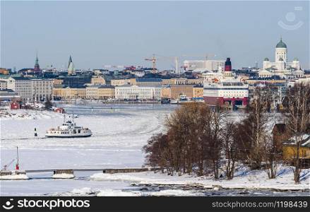 A view of the city and navigation in the port of Helsinki on a sunny winter day. Finland