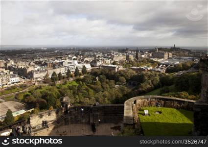 A view of the city of Edinburgh, Scotland as seen from above in a panorama view from the vantage point of Edinburgh Castle.