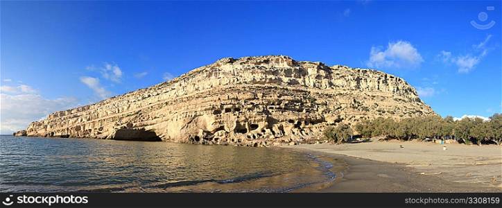 A view of the cliffs at Matala, Crete, with Roman graves cut into them. The tilting of the island which has raised Falasarna Roman harbour out of the sea in the East has submerged some of the graves here, as can be seen near the shore-line.