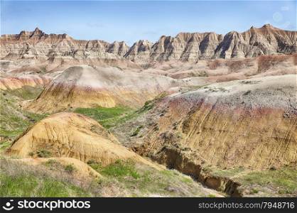 A view of the colored mounds in one of the valleys of the Badlands National Park in South Dakota that shows off the range of colors in the hills.