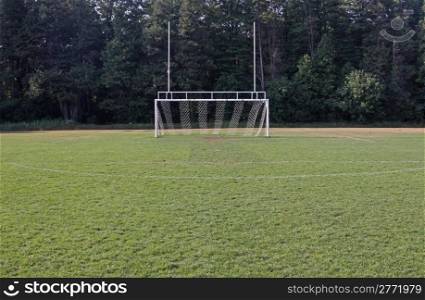 A view of the goal on a vacant soccer pitch.. Attack the Goal