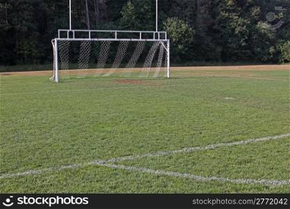 A view of the goal on a vacant soccer pitch.. Soccer Net