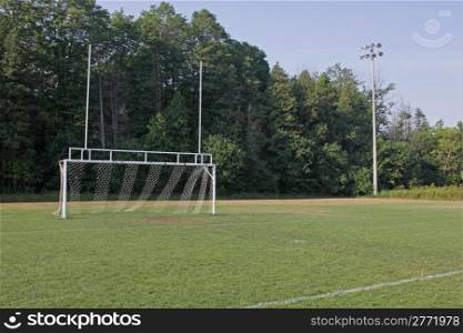 A view of the goal on a vacant soccer pitch.. Wide View of Soccer Pitch
