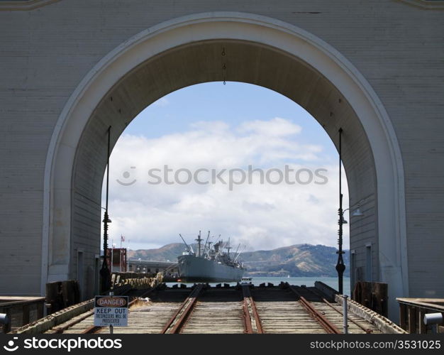 A view of the Jeremiah O&rsquo;Brian liberty ship and the Marin Headlands. The archway and the rails in the foreground serve as a launch for boats into San Francisco harbor.