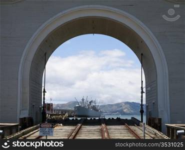 A view of the Jeremiah O&rsquo;Brian liberty ship and the Marin Headlands. The archway and the rails in the foreground serve as a launch for boats into San Francisco harbor.