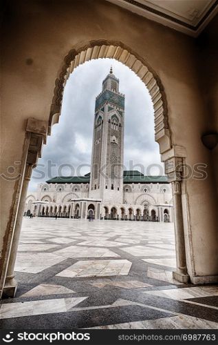 A view of the King Hassan II Mosque in Casablanca, Morocco as seen through an arch.