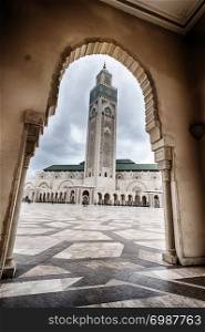 A view of the King Hassan II Mosque in Casablanca, Morocco as seen through an arch.
