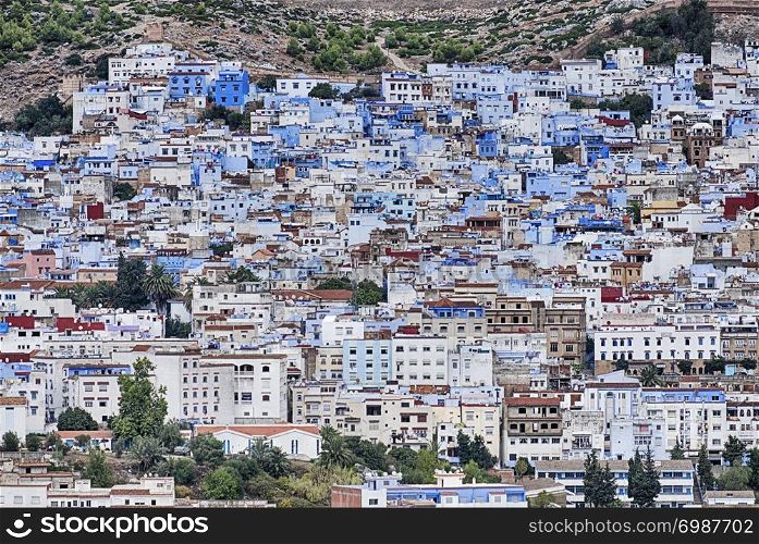 A view of the Medina, or Old City, of Chefchaouen in Morocco shows many buildings painted with bright blue paint.