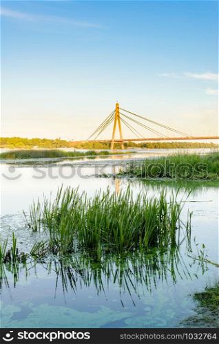 A view of the Moskovsky bridge over the Dnieper river in Kiev, Ukraine, during a blue summer evening