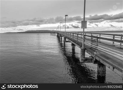 A view of the pier in Des Mointes, Washington. Black and white image.