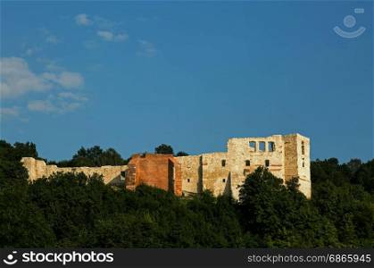 A view of the ruins of a castle among the forest on a background of blue sky, July 2017 in Kazimierz Dolny (Kazimierz on Vistula river).Editorial.Horizontal view.