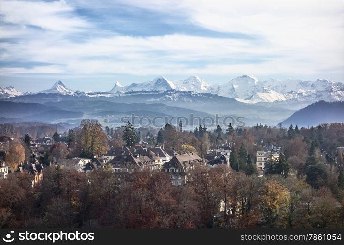 A view of the Swiss Alps as seen over the outskirts of Bern. In the center of the peaks are the Eiger, the Munch and the Jungfrau mountains.
