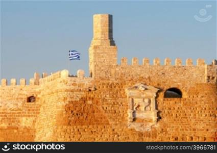 A view of the Venetian Fortress and the Greek flag over her early in the morning. Crete.. Heraklion. The old Venetian fortress.