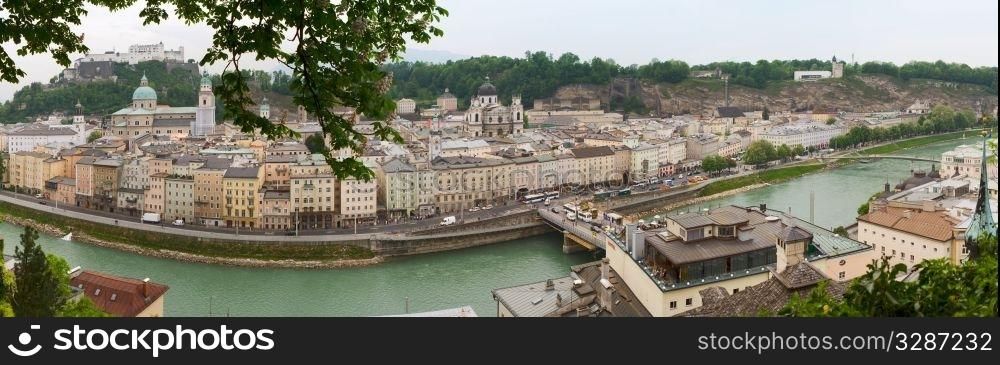 a view right from the hill into the city center of Salzburg - Austria..Panoramic image of Salzburg. Mozart&rsquo;s old town with Alps in the far background.