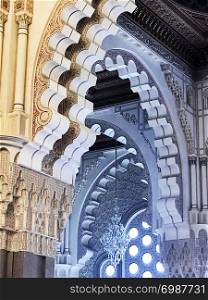 A view showing parts of five different arches, in the traditional Islamic architectural style, inside the King Hassan II mosque in Casablanca, Morocco.