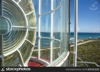 A view to the most Southern point of Africa from the top of a lighthouse with part of the light in view.